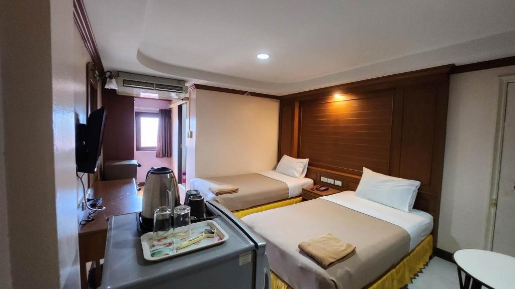 Postel nebo postele na pokoji v ubytování White Rose​ Hotel​ II​