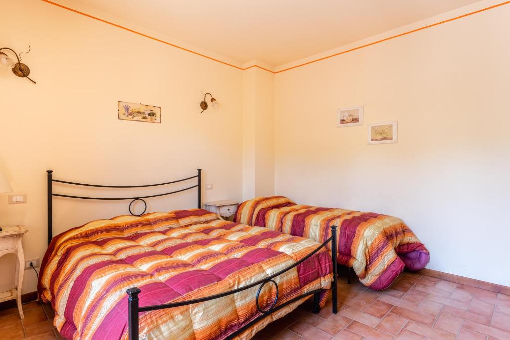 Postel nebo postele na pokoji v ubytování Casolare dei Fiori - Mughetto