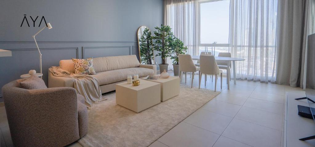 a living room with a couch and a table at AYA Boutique - Beach View in this 1BR Apartment in Dubai Marina in Dubai