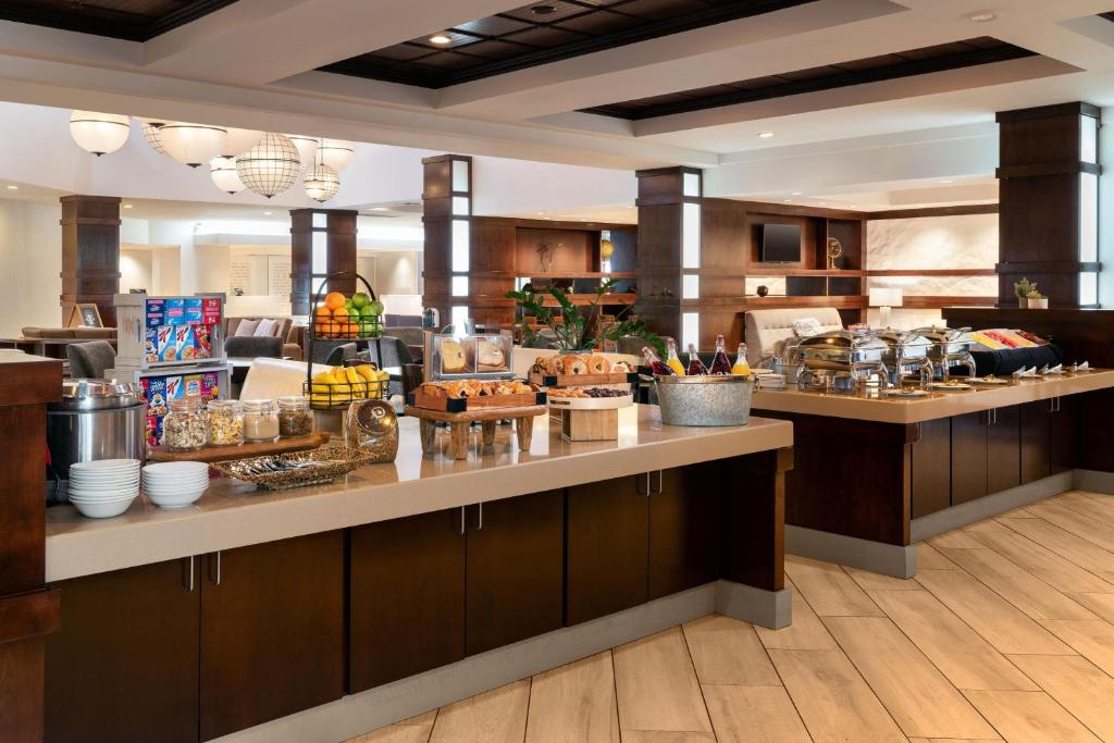 a restaurant with a counter with food on it at Fullerton Marriott at California State University in Fullerton