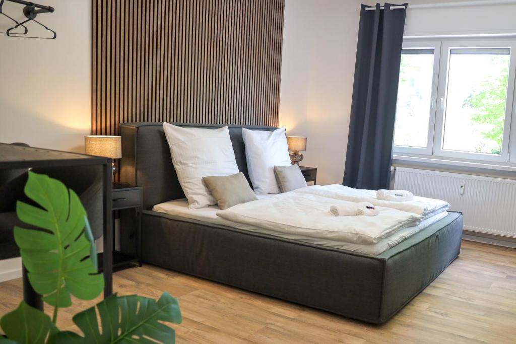 a bedroom with a bed with a large window at JAWO Apartments Koblenz modern & zentral in Koblenz