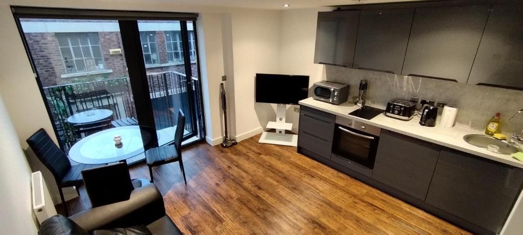 a kitchen with wooden floors and a large window at Earl Street 122 in Sheffield