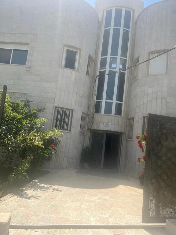 a large stone building with a door and windows at Ajloun Rest House in ‘Ayn Jannā