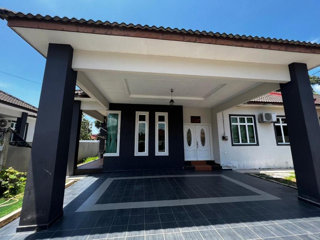 a house with a black and white at 4 bedrooms house with Private Pool ! in Kota Bharu