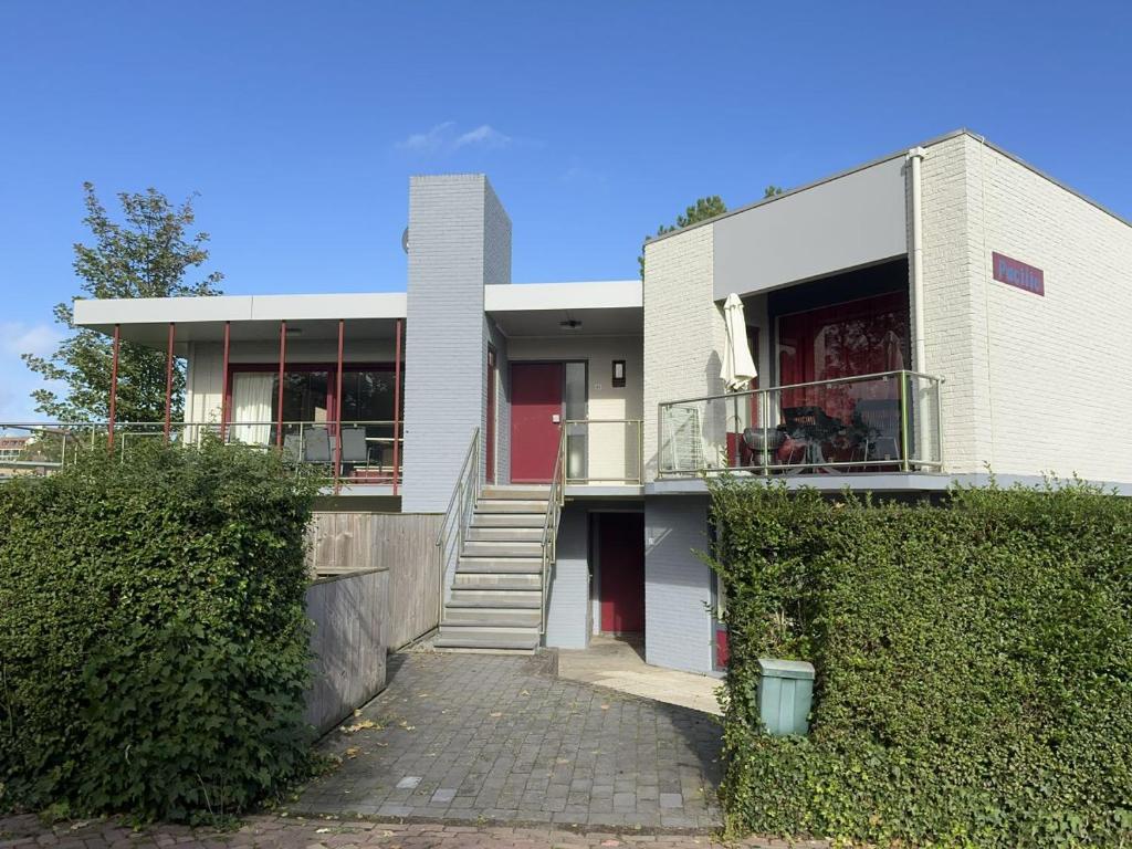 a white house with a staircase leading to it at Pacific, Wijk de Brabander 63 in Cadzand