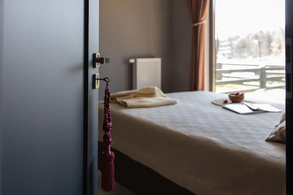 a bedroom with a bed with a view of a window at BlueWater Apartment in Mikołajki