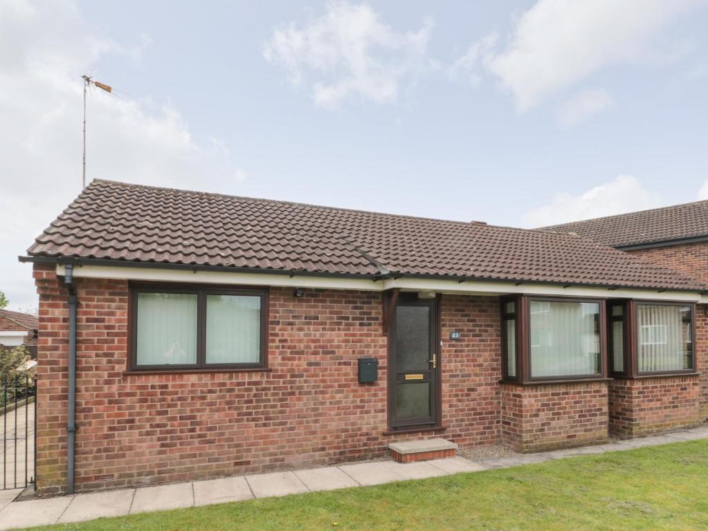 a brick house with a brown roof at Red Tree Cottage in York