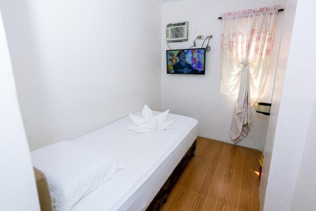 Postel nebo postele na pokoji v ubytování FB Budgetel Suites