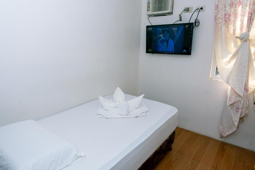 Postel nebo postele na pokoji v ubytování FB Budgetel Suites