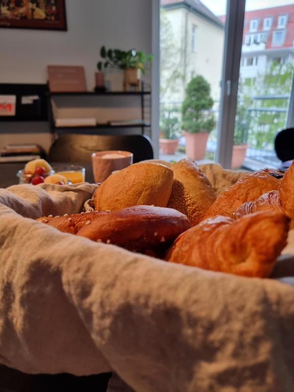 a bunch of bread sitting on a table at Das Altschwabing - Munich Boutique Hotel in Munich