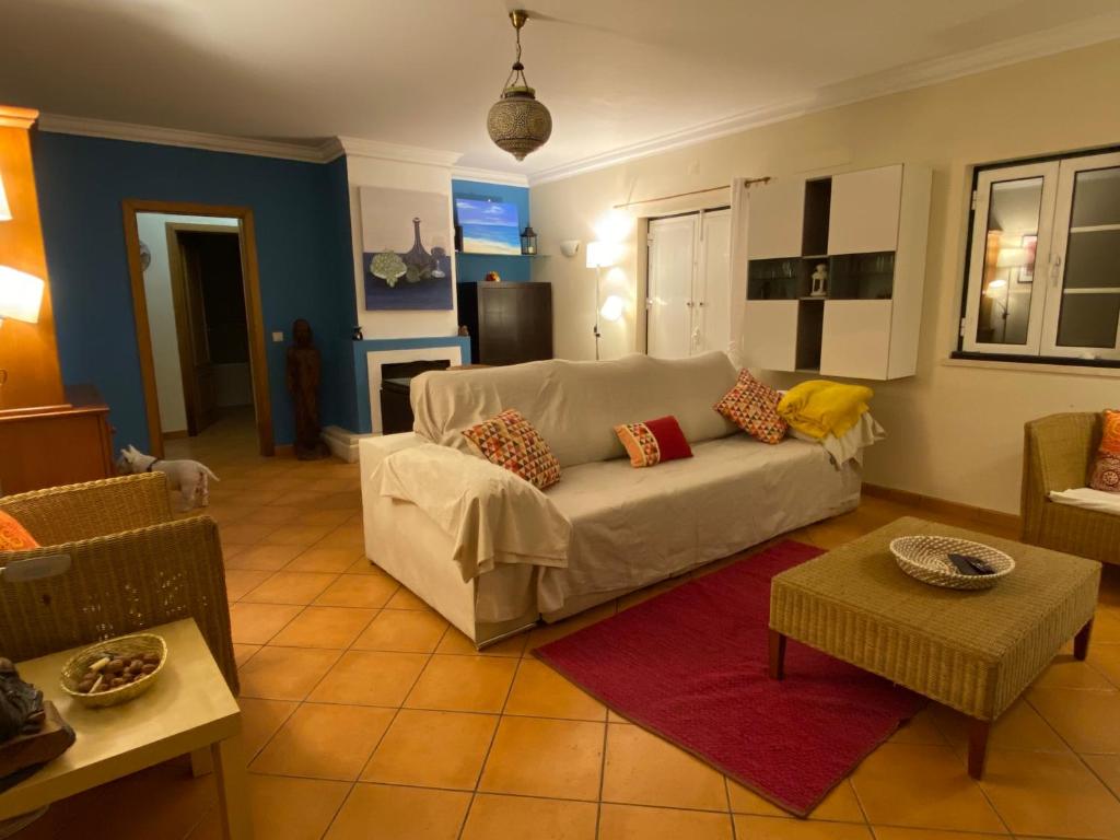 a living room with a couch and a table at CASA DOS 2 PÁTIOS by Stay in Alentejo in Vila Nova de Milfontes