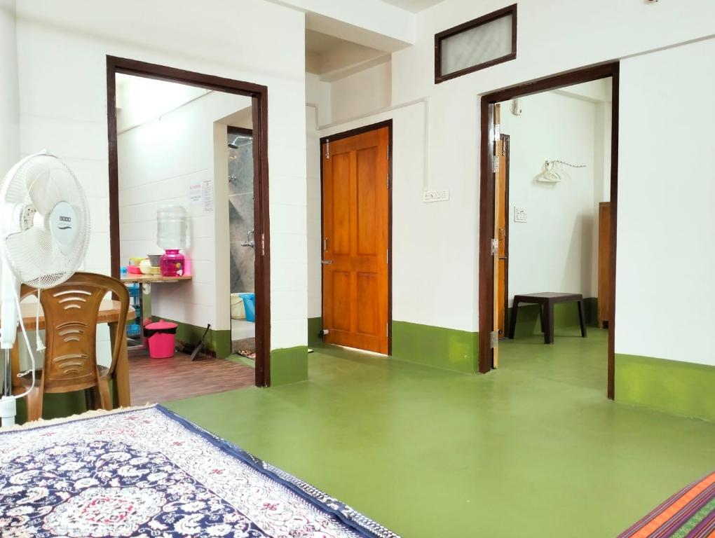 西里古里的住宿－Yangzom Homez，客房设有一张床和一张桌子及椅子