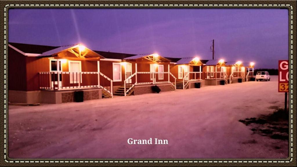 Una fila de casas iluminadas por la noche en Grand Inn, en Big Lake