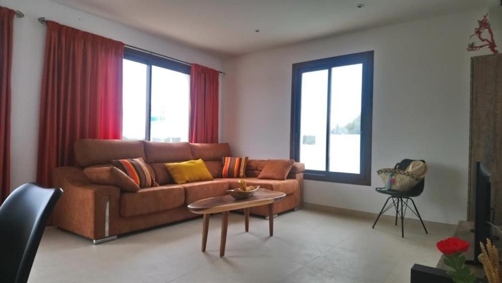 een woonkamer met een bank en een tafel bij Casa cerca de Sant Francesc ET6394 in Sant Francesc Xavier