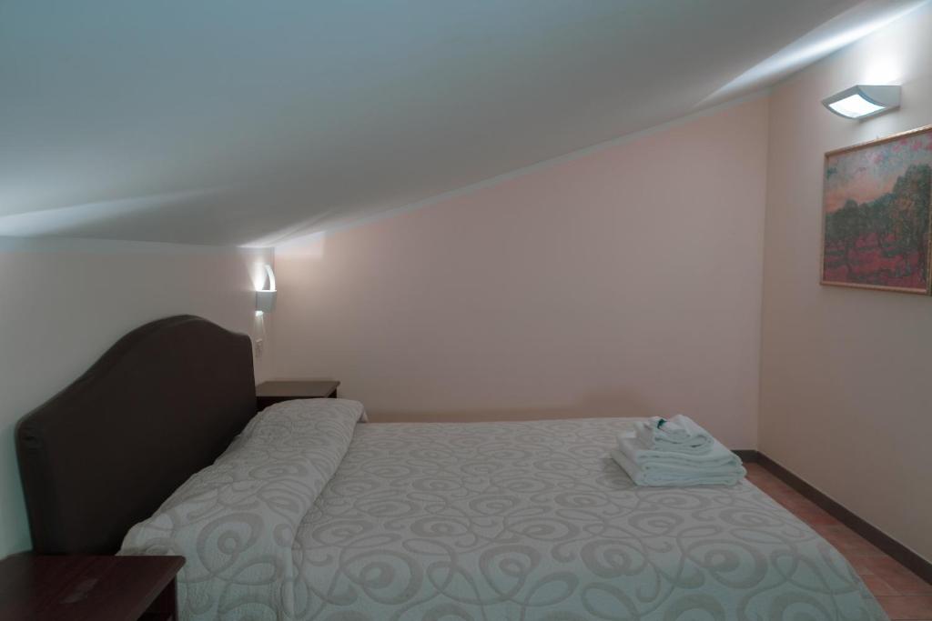 Cama ou camas em um quarto em Carpediem Assisi Living Club