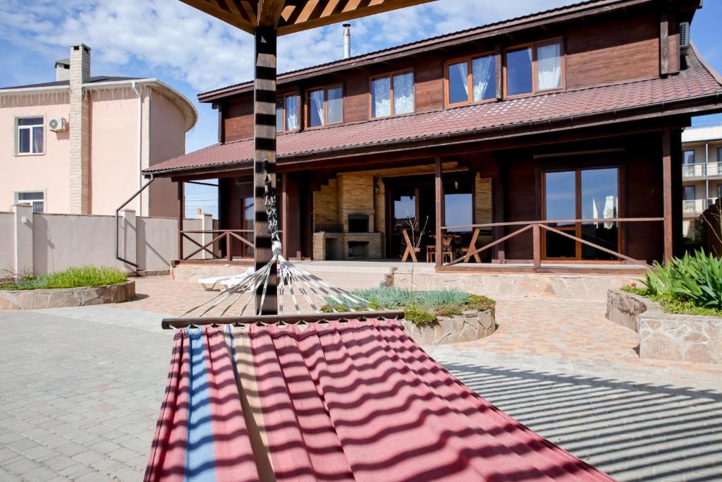 a hammock in front of a house at Villa SeaZone in Zatoka