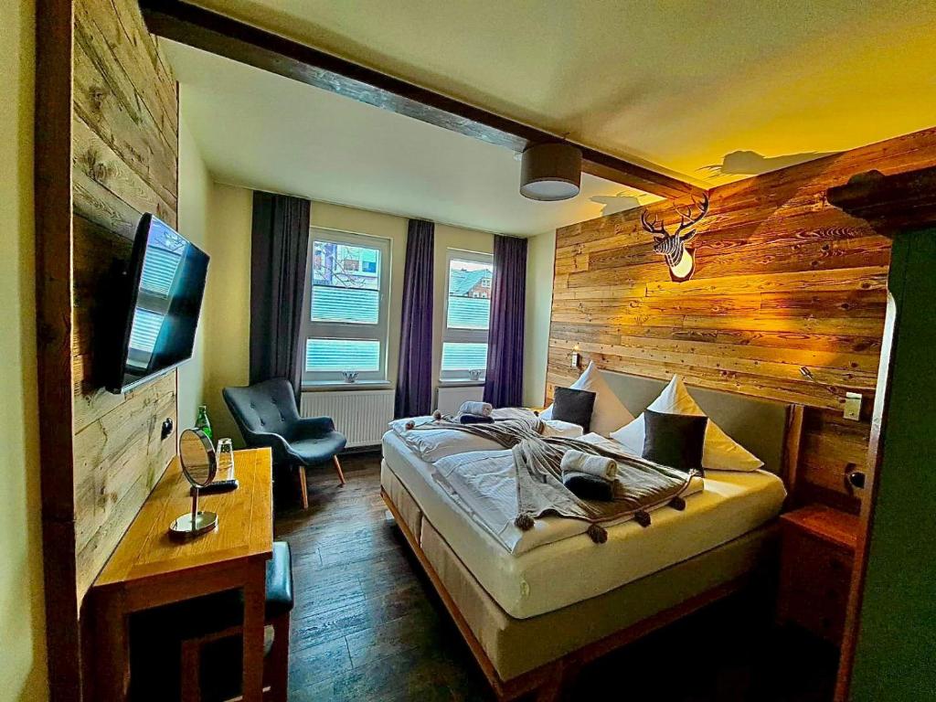 a bedroom with a bed and a television in it at Ferienwohnung HarzReise in Braunlage