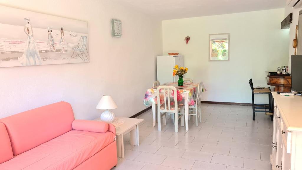 a living room with a couch and a table at Appartamento- La Casa del Mirto- Porto Rotondo in Porto Rotondo