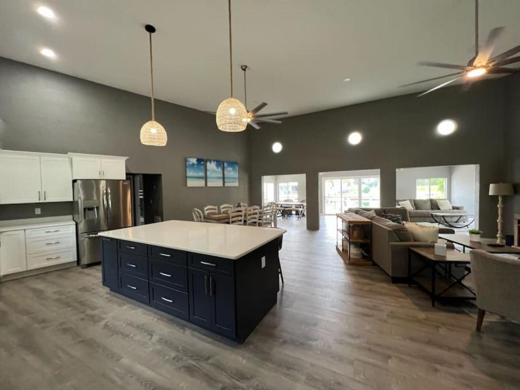 a large kitchen and living room with a counter top at Spacious 4 bedroom with 2 baths with Pool and boat dock in Crystal River