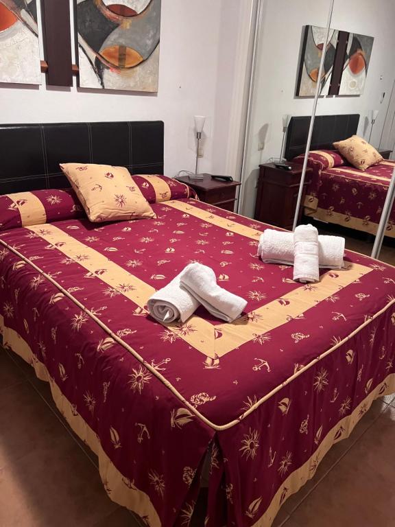 a bedroom with a bed with towels on it at Apartamento Zahara in Zahara de los Atunes