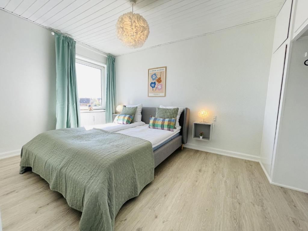 a bedroom with a bed and a window at aday - Greenway 2 bedrooms apartment in Frederikshavn