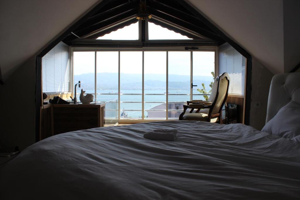 a bedroom with a bed and a large window at Köşk Nicomedia in Izmit