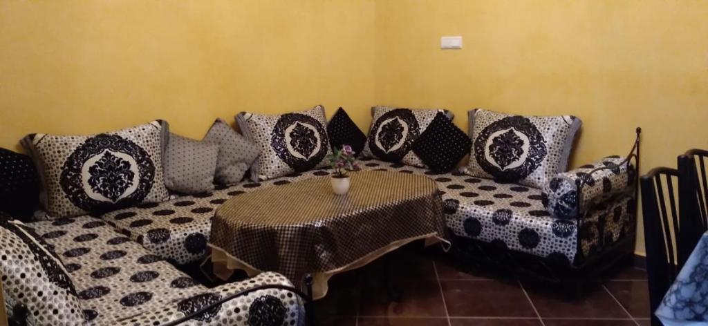 a couch with a table in a room at TOP Appartement in Aourir