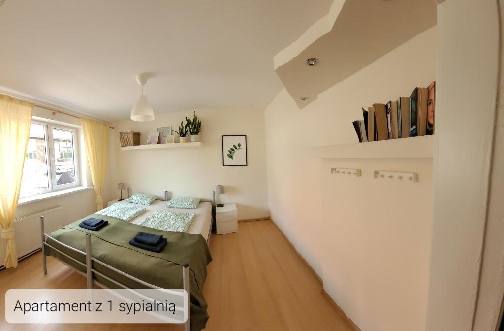 una piccola camera con due letti e una finestra di LuLu Apartamento Centro a Łagów