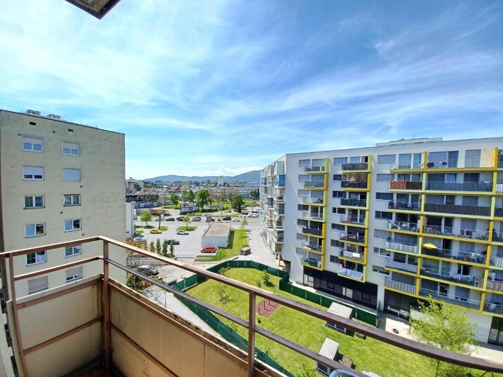 an apartment balcony with a view of a parking lot at BrightCenterApartment in Graz