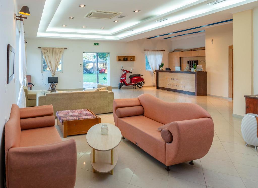 a living room with two couches and a table at Zenstay Hotel in Áyios Nikólaos Nirás