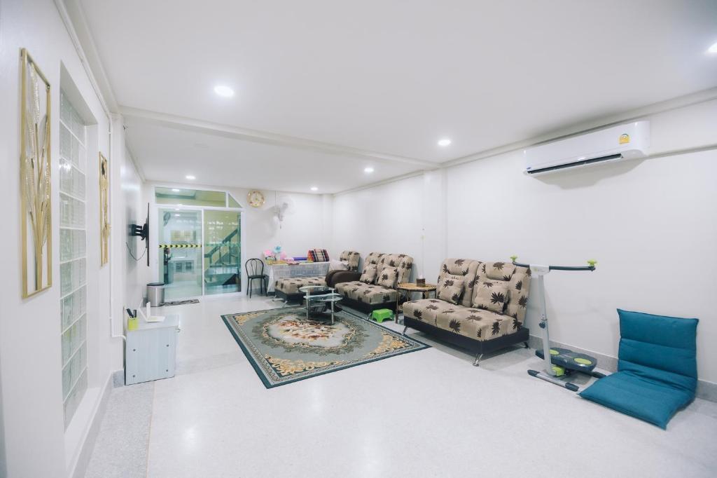 a living room with couches and a table at Paradise Found - Hat Yai 292sqm Family Home in Hat Yai