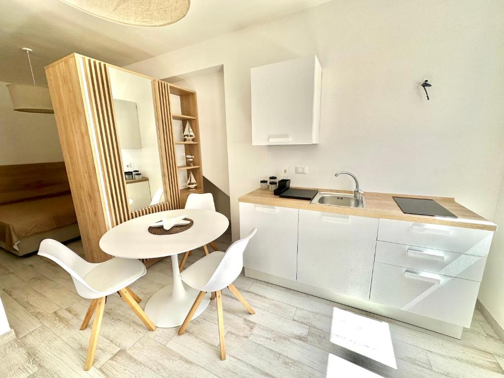 a kitchen with a table and chairs and a sink at Bilocale Vista Mare in Marettimo
