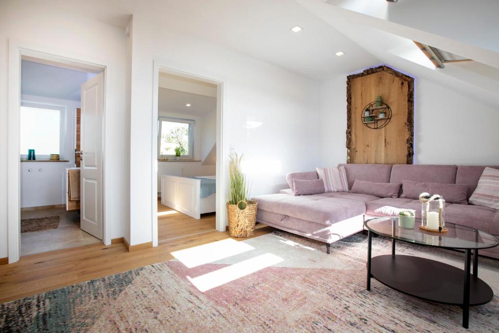 a living room with a couch and a table at Ferienwohnung Untersbergblick in Salzburg