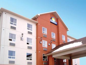 a red and white building with a sign on it at Days Inn by Wyndham Athabasca in Athabasca