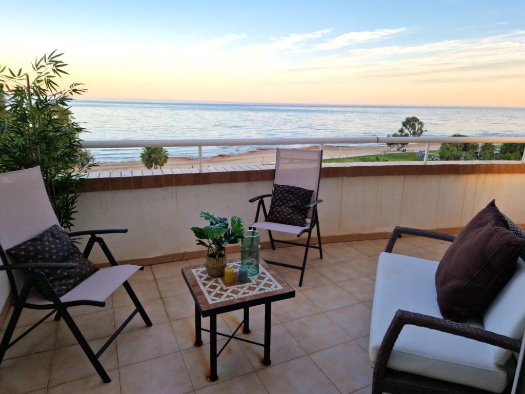 a balcony with chairs and a table with a view of the ocean at Vistas Mágicas Mar Mediterraneo in Oropesa del Mar