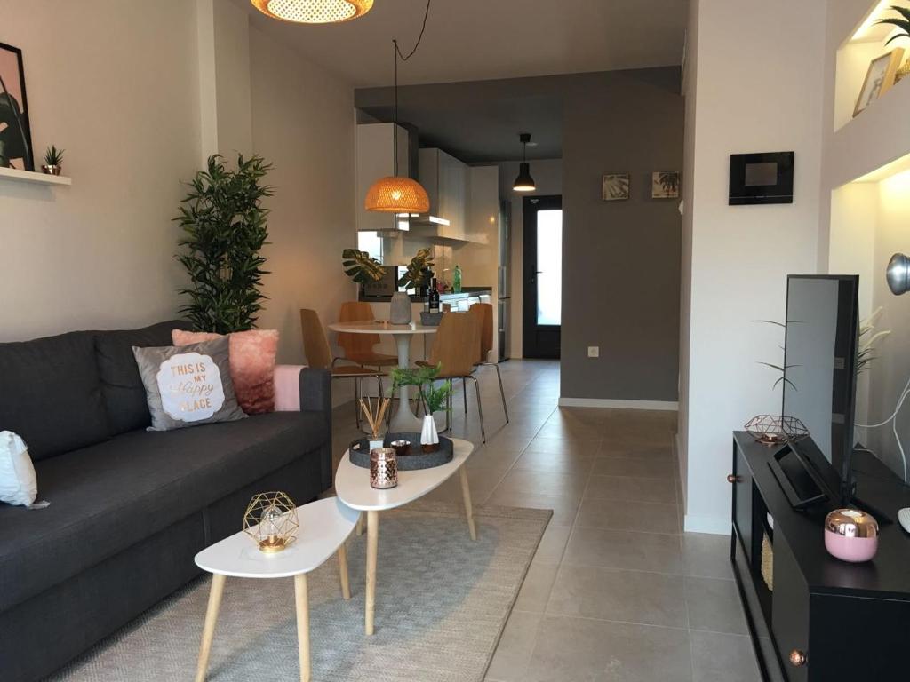a living room with a couch and two tables at Private House 3 bedrooms with garden - Torre de la Horadada in Torre de la Horadada