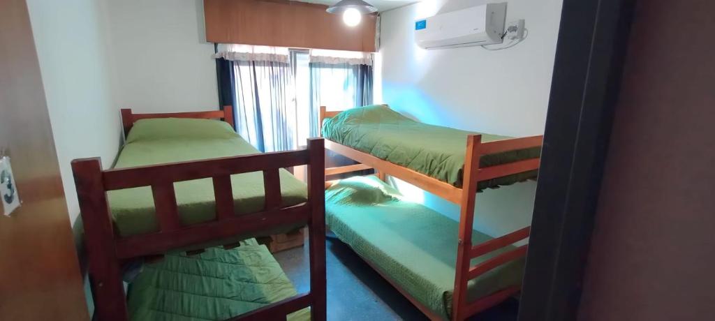 a bedroom with two bunk beds in a room at Destino San Juan Hostel in San Juan