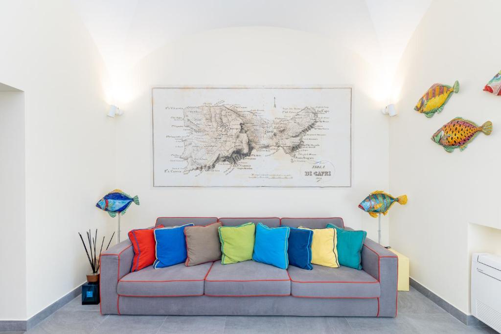 a couch with colorful pillows on it in a room at Casa Dani Capri in Capri