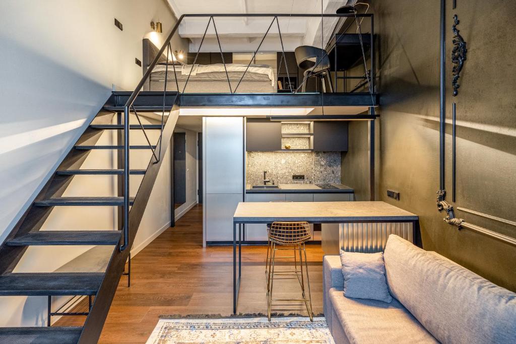 a loft apartment with a staircase and a living room at Stylish Black and White loft in Kaunas