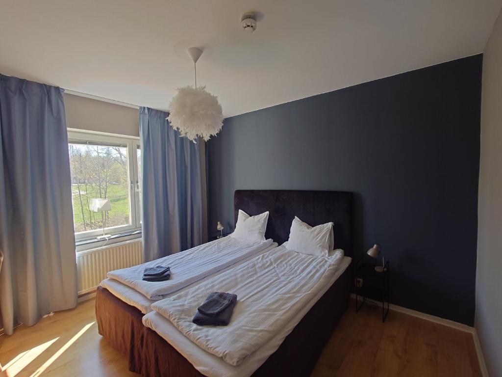 a bedroom with a large bed with a large window at Vena Värdshus in Vena
