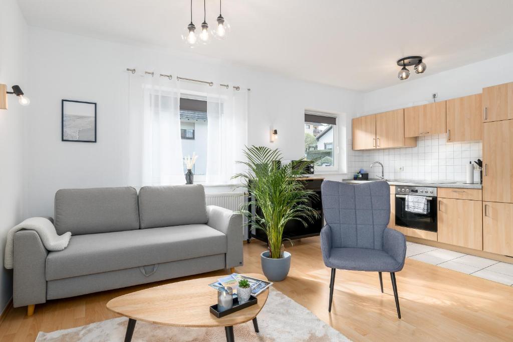 a living room with a couch and a table at Harmony: Edersee Apartment – Sperrmauer – Lounge in Edersee