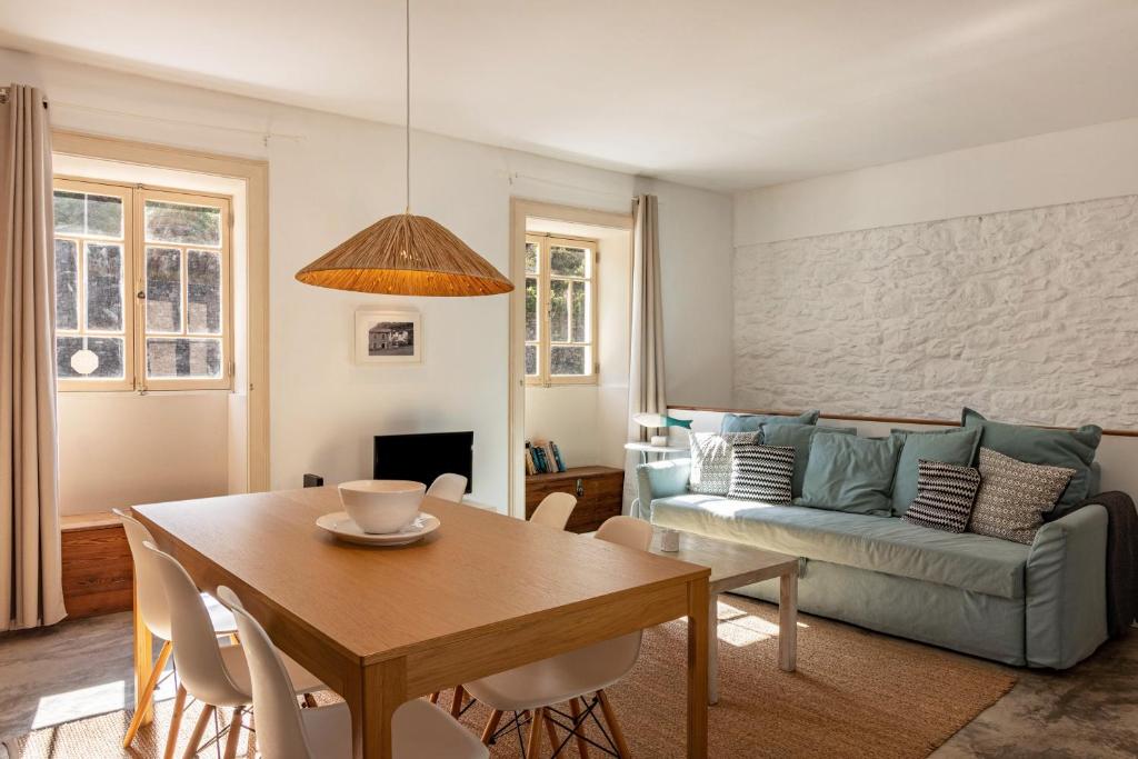 a living room with a table and a couch at Calheta Beach House T2 in Calheta