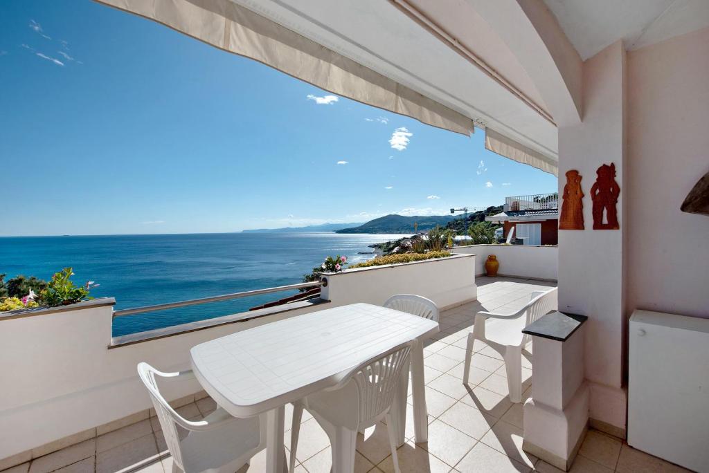 a balcony with a table and chairs and a view of the ocean at Casa Nina in Arenzano