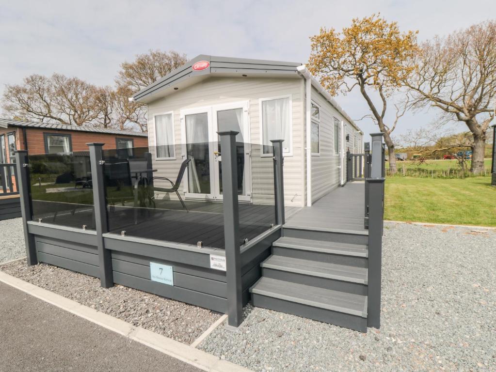 a tiny house with a porch and a deck at Lodge 7 - Seabreeze Retreat in Bridlington