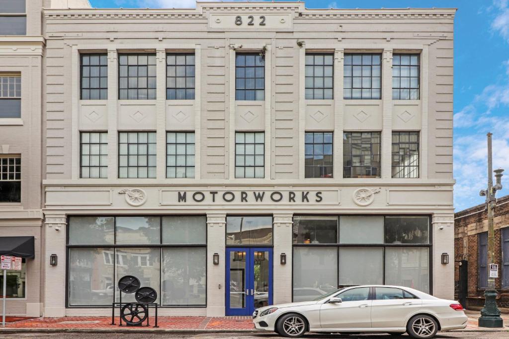 a white car parked in front of a building at Roami at Motorworks in New Orleans