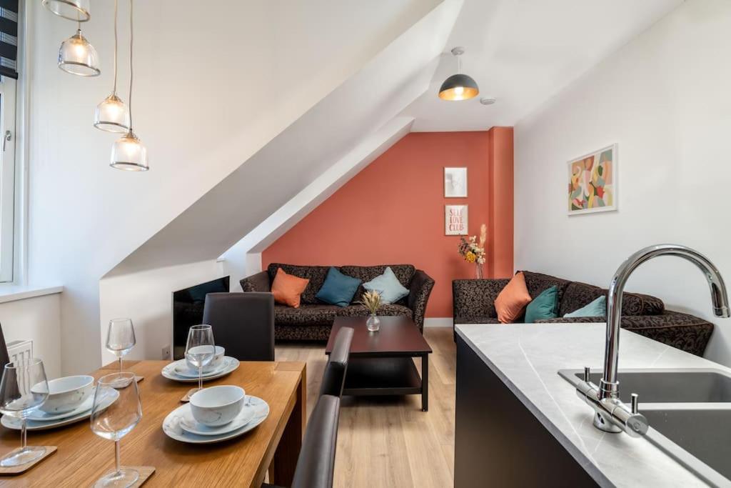 a kitchen and living room with a couch and a table at Remodelled Luxury 3 Bed Apartment in Aberdeen