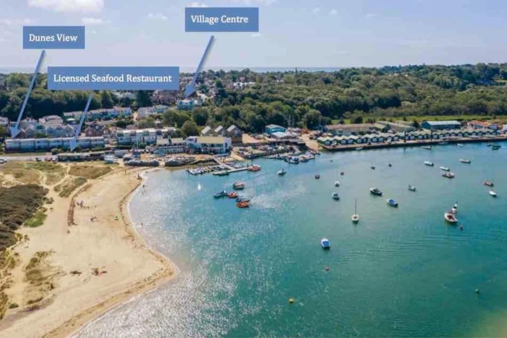 an aerial view of a beach with boats in the water at Dunes View, waterside home with stunning views. in Bembridge