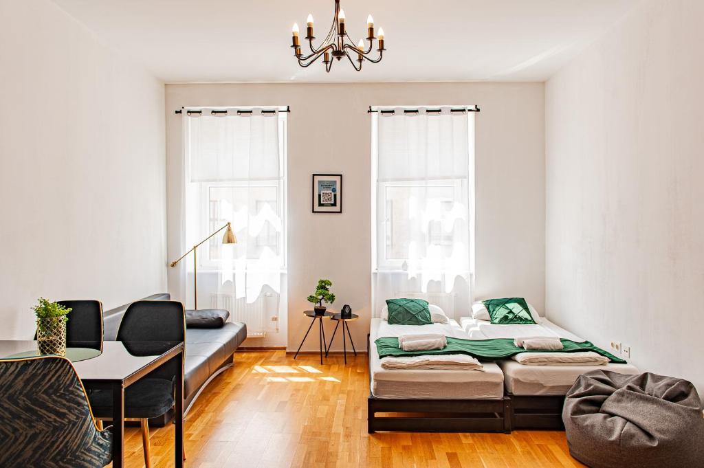 a living room with a bed and a table at My city apartment - Vienna CityRoom in Vienna