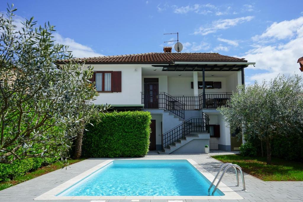 a villa with a swimming pool in front of a house at Leon with Private Pool in Sveti Petar u Šumi