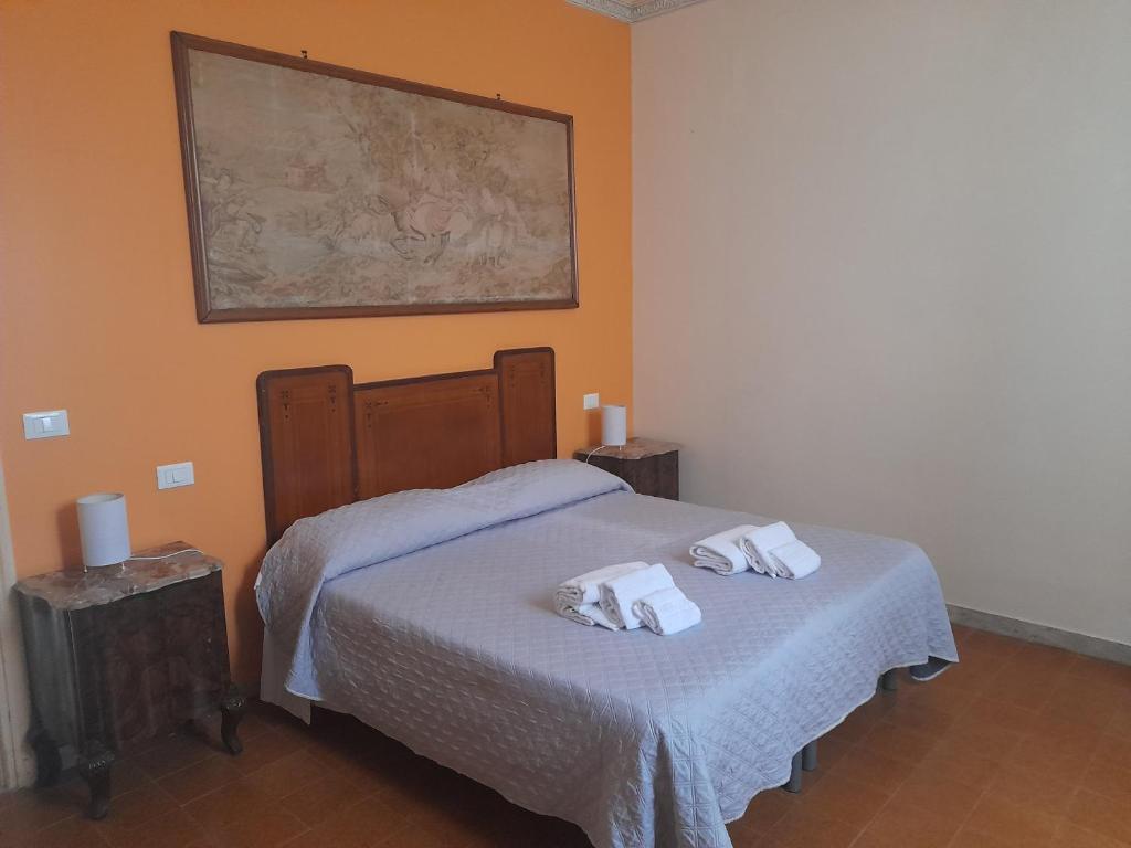a bedroom with a bed with two towels on it at M&D Appartamenti in Trapani